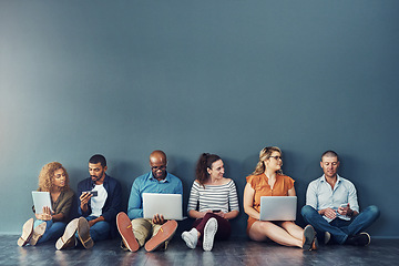 Image showing Diverse digital team exploring online platform on many devices, sitting against copy space together. Social advertising and global networking, collaborating with technology, connecting global network