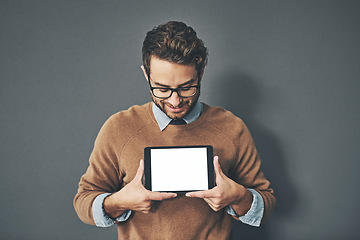 Image showing Person holding copyspace, blank and empty tablet screen with an internet app in studio against a grey background. Advertising, marketing and endorsing a product, service or website with copy space