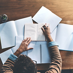 Image showing Thinking, planning and brainstorming business man reading and writing notes at a desk from above. Creative male drawing mindmap and planning a mission, goal or vision for innovative strategy