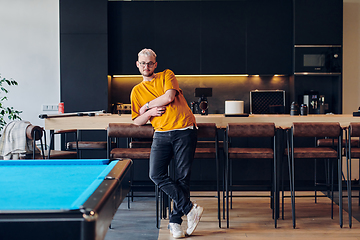 Image showing A man takes a brief rest from work in a modern startup coworking center, using the moment to recharge and relax with technology by his side.