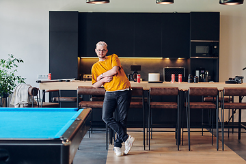 Image showing A man takes a brief rest from work in a modern startup coworking center, using the moment to recharge and relax with technology by his side.