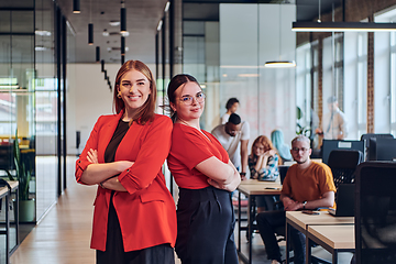 Image showing Group of determined businesswomen confidently pose side by side in a modern startup coworking center, embodying professionalism and empowerment