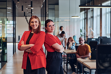 Image showing Group of determined businesswomen confidently pose side by side in a modern startup coworking center, embodying professionalism and empowerment