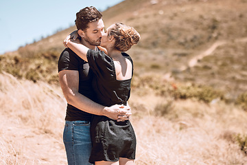 Image showing Kissing, relaxed and romantic couple enjoying love, bonding and break on getaway together on a sunny day outdoors. Boyfriend and girlfriend in a loving relationship on honeymoon, holiday and date