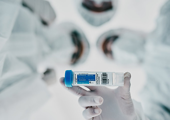 Image showing Healthcare scientists holding a vaccine, test tube and medical treatment while doing covid research in a laboratory. Group of science technicians standing together with the cure for corona virus