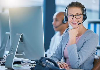 Image showing Call center agent, telemarketing employee or customer service worker is happy and smiling in the office. Portrait of a caucasian female sales representative ready and excited to help and answer calls