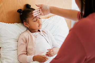 Image showing Sick child with mother checking forehead temperature, feeling ill and unwell. Small girl with illness, fever or disease at home in bed resting, sleeping and recover from infection, flu or covid virus