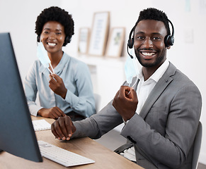 Image showing Customer service agents working on computer, helping people online and giving support while sitting together at work. Portrait of smiling African call center agents removing face at end of pandemic