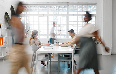 Image showing Blurred designers, marketing or freelance professionals working together in a modern office. Business men and women busy, walking and active in a creative workplace, workstation or environment
