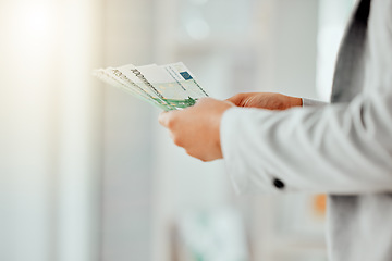 Image showing Money, finance and banking in the hands of a financial advisor, investment broker or wealth manager. Closeup of cash, currency or bills being held by a foreign exchange professional or money changer