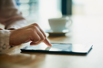 Image showing Closeup of business hands working on a digital tablet in a modern office. Professional at work on touch screen browsing the online market for data or information on trading, investment or growth.