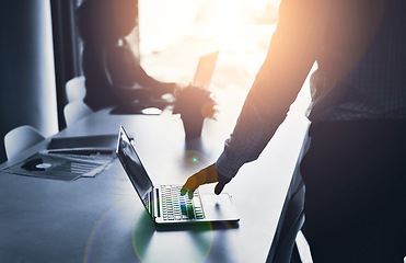 Image showing Silhouette of a business man hand working on a laptop at an IT company and having a meeting in an office. A male employee typing in a dark boardroom during a meeting or presentation