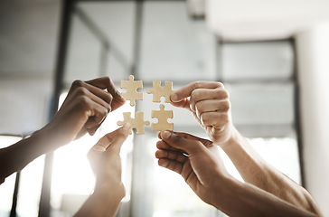 Image showing Business people hands with puzzle showing solution, problem solving and teamwork. Smart group or team activity completing, finishing a task project or assignment in difficult challenging work crisis