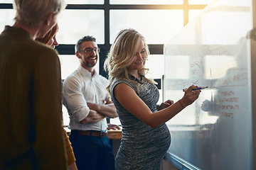 Image showing Pregnant team leader presenting strategy, writing vision and motivating group of corporate executives on whiteboard. Manager and leader explaining innovation plan or company development to colleagues