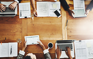 Image showing Above desk of accounting colleagues having a meeting and analyzing big data in office. Businesspeople planning with papers and multiple devices for growth development and innovation with copy space