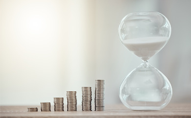 Image showing Cash coins for a future investment with hourglass, savings and growth of finance at the bank. Sand clock countdown for opening of the financial economy market. Money for a corporate business budget.