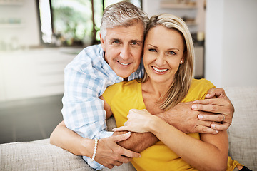 Image showing Happy, in love and affectionate senior couple hugging on the sofa in the living at room, enjoying time together and their retirement. Portrait of a happy man and woman bonding and smiling at home