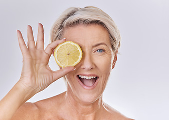 Image showing Skincare, wellness and face of mature woman with wrinkles holding lemon with nutrition, vitamins and health. Portrait of happy senior lady with fruit and healthy, organic and fresh self care routine.