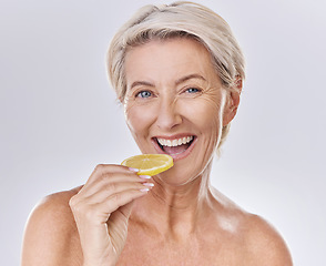 Image showing Health, nutrition and wellness of a mature woman happy in her aging skin care, beauty and face. Portrait of an old female model with a lemon promote a healthy natural lifestyle for skincare benefits