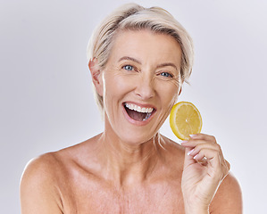 Image showing Skincare, health and face of senior lady with a healthy lifestyle holding an organic lemon. Portrait of a happy mature female with wrinkles doing a fresh citrus fruit body care wellness routine.