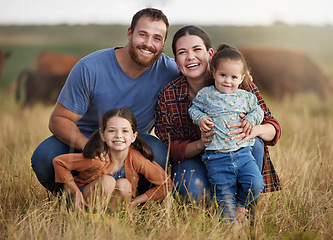 Image showing Portrait of happy family on a countryside farm field with cows in the background. Farmer parents bonding with kids on a sustainable agriculture cattle business with a smile and happiness together
