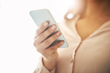 Image showing Phone in hand, communication and networking with a woman reading, typing or sending a text message. Closeup of a female browsing social media, surfing the internet and checking news online with flare