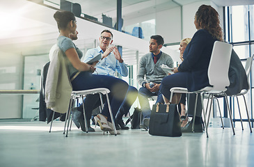 Image showing Teamwork, collaboration and strategy planning of business team working together indoors. Modern office workers talking and sitting in a group meeting. Colleagues work and talk about a project