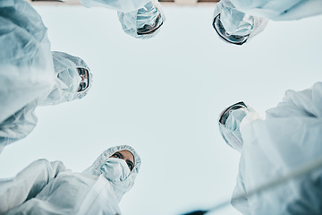 Image showing Covid pandemic outbreak team of doctors or medical workers wearing protective ppe to prevent spread of virus in hospital. Group of scientists wearing hazmat suits for corona or ebola disease in lab.