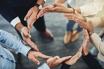 Image showing Circle of hands, teamwork and togetherness with a group of business colleagues standing in a team huddle from above. Working together, showing unity and giving support in a meeting for motivation