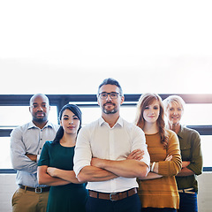Image showing Portrait of a group of confident and serious professionals standing together with arms crossed and copyspace. Serious team leader, manager or entrepreneur leading with support of staff and colleagues