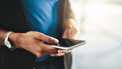 Image showing Businesswoman texting on phone, networking on social media and browsing internet at work. Closeup of the hands of a professional employee checking a text, scrolling an online app and reading messages