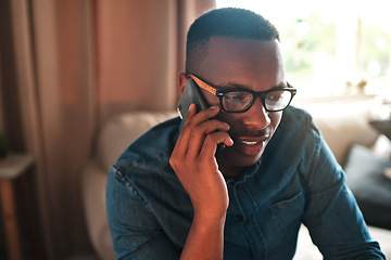 Image showing Young student talking on a phone call to a friend, colleague or family member. Black male university or college learner studying design, marketing or architecture sitting and chatting at home