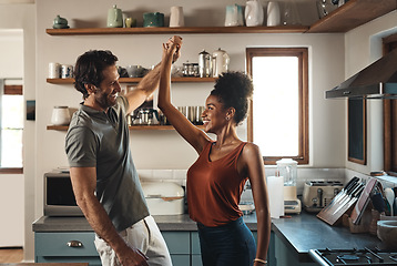 Image showing Happy, in love and dancing while an interracial couple have fun and enjoying time together in home kitchen. Husband and wife sharing a dance while being active and affectionate in loving relationship