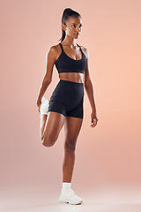 Image showing Fitness, exercise and workout athlete stretching out her legs before training indoors to stay healthy and young. Active, body and sporty woman warms up strong muscles for her motivated lifestyle