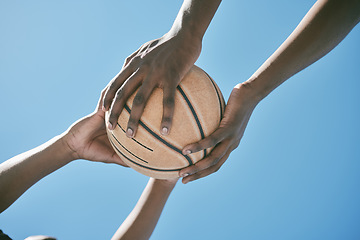 Image showing Basketball, sports and competition with players holding a ball against a blue sky with copy space from below. Closeup hands of black male athletes and friends playing or training for a game outside