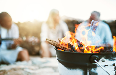 Image showing . Closeup hot, warm and burning fire outside during a camp, trek or hike in nature. Group of friends taking a break from an adventure, journey or hiking outside near a flame in the rural wilderness.