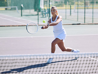 Image showing Active, fit and sporty athletic tennis player playing a friendly match at a tennis court. Female athlete learning to balance in a practice game. Lady enjoying fitness hobby she is passionate about.