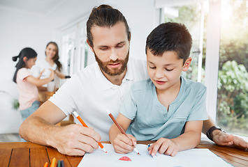 Image showing Father and son bonding, drawing and learning with the family in the background at home. Little boy and his male parent coloring in and having fun while doing homework and spending time together