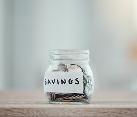Image showing Savings, money and finance with many silver coins in a jar for retirement, banking and investment growth. Start to save for college, pension or wealth with financial freedom from saved income