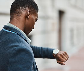 Image showing Running late, checking time on watch and feeling stressed, anxious and in hurry to get to work. Rushing entrepreneur in city, town or downtown missing a morning office appointment or public transport