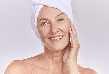 Image showing Portrait of happy woman wear a towel on head after enjoying a refreshing shower and healthy skincare. Senior beauty, cosmetic and face model smile while posing against a grey copy space background