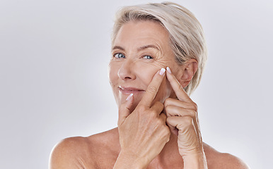 Image showing Acne or pimple popping female or woman after night face skincare beauty treatment for healthy and clear skin copy space. Portrait of happy senior woman use cosmetics with hands to target wrinkles