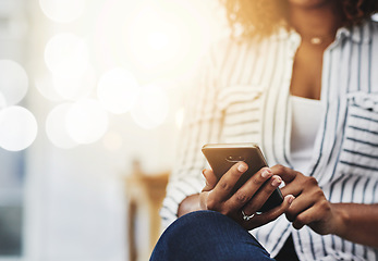 Image showing Closeup of woman hands holding, typing and using a phone to browse the internet. Young casual female on smartphone texting, messaging and chatting with friends on social networks.