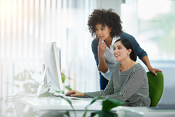 Image showing Young creative designers working together on a computer at a desk in a modern office. Women in design thinking, strategy and collaborating at work on a project with technology in the workplace.