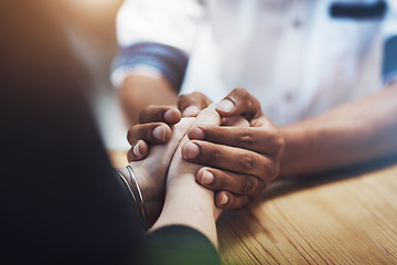 Image showing Interracial couple holding hands in support, comfort and trust while bonding and feeling united in home living room. Closeup of man touching, comforting or caring for woman who has anxiety in therapy