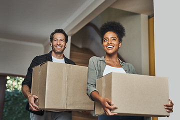 Image showing New house, moving and happy couple carrying boxes while feeling proud and excited about buying a house with a mortgage loan. Interracial husband and wife first time buyers unpacking in dream home