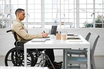 Image showing Wheelchair, disabled and handicap business man working, planning and writing ideas in an inclusive, accessible and independent office workplace. Physically impaired, focused and serious entrepreneur