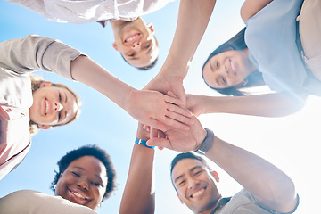 Image showing Group of friends hands stacked in success and unity from below for teamwork, collaboration and outdoors bonding. Diverse team showing support, togetherness and community, united for a common goal.