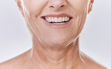 Image showing Senior woman with perfect white teeth, dental or Invisalign results and happy mouth closeup in studio. Mature model with a smile for good dentistry health insurance or excellent oral hygiene service