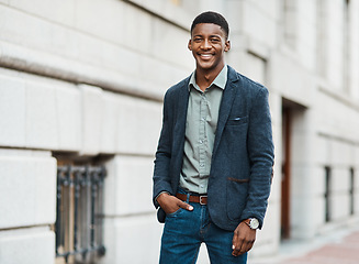 Image showing Stylish, trendy and handsome businessman walking to work in the city alone. Portrait of a cool black male entrepreneur commuting to his job and looking happy, carefree and cheerful in the morning